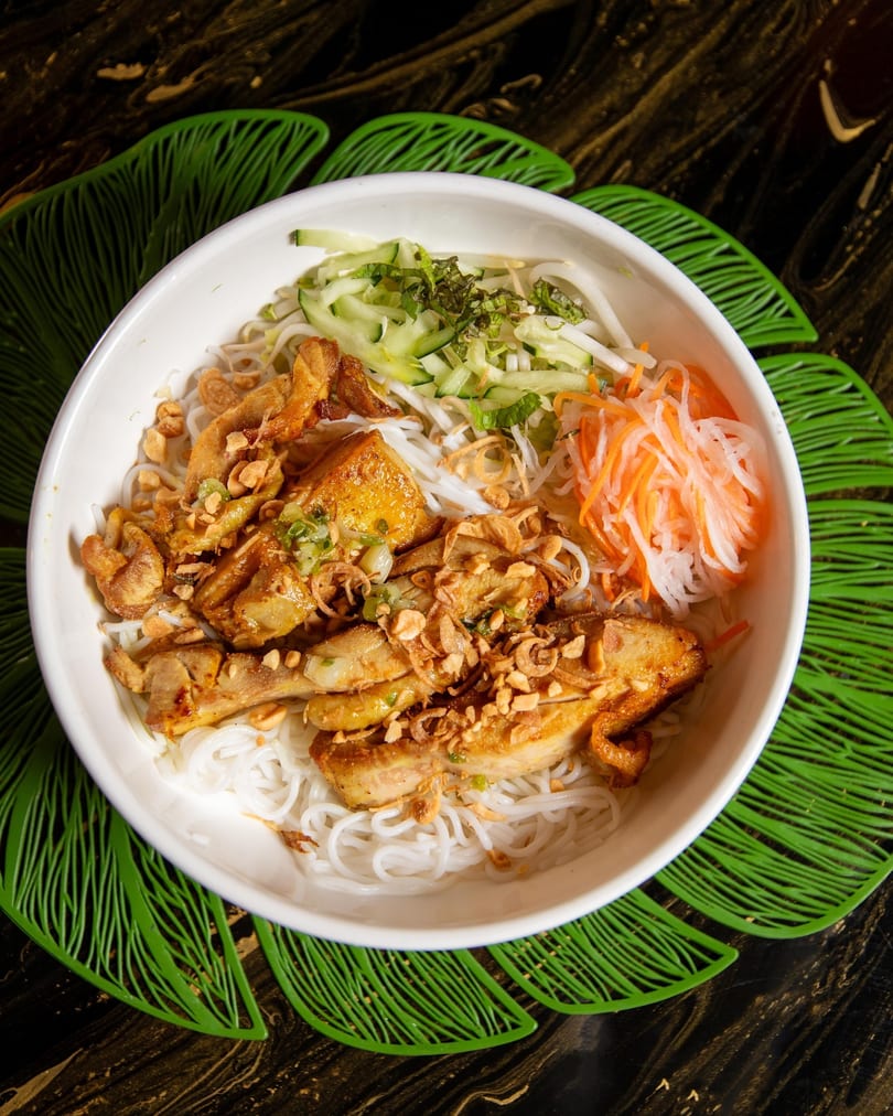 Vietnamese vermicelli bowl with grilled chicken, peanuts, fried onions, and pickled vegetables.